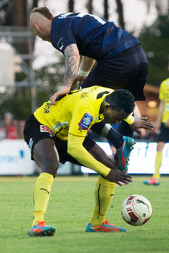 Malmös Magnus Eriksson flyger över Mjällbys Gbenga Arokoyo  i den allsvenska matchen mellan Mjällby och Malmö FF i Hällevik 22 maj  2014.