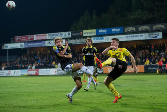 Mjällbys Viktor Agardius rensar framför Anton Saletros  i matchen i allsvenskan mellan Mjällby och AIK i Hällevik 24 september 2014.
