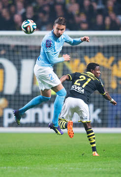 s Erik Johansson vinner en luftduell mot AIK:s Kennedy Igboananike under fotbollsmatchen i Allsvenskan mellan AIK och Malmö FF den 5 oktober 2014 i Stockholm.
