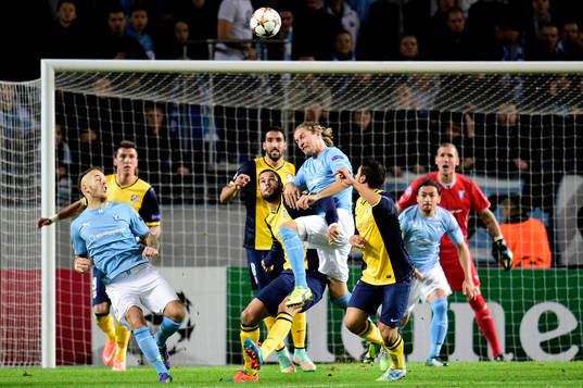 s Magnus Eriksson och Markus Halsti i kamp med Atletico Madrids Arda Turan under fotbollsmatchen i Champions League mellan Malmö FF och Atlético Madrid den 4 november 2014 i Malmö. 