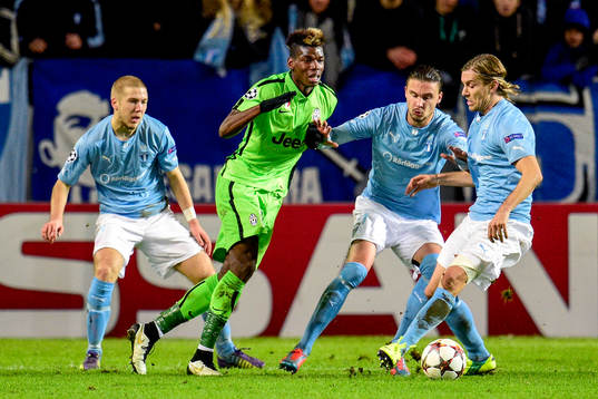 s Anton Tinnerholm  Erik Johansson och Markus Halsti och Juventus Paul Pogba under fotbollsmatchen i Champions League mellan Malmö FF och Juventus den 26 november 2014 i Malmö. 