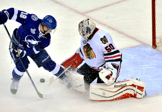 Chicago goalie Corey Crawford (50) stops a shot from Tampa