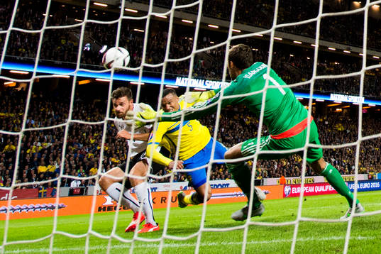 Österrikes Marek Harnik gör 0-2 bakom Sveriges målvakt Andreas Isaksson i kamp med Martin Olsson