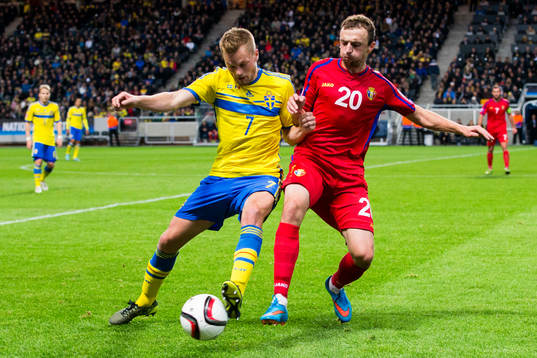 Sveriges Sebastian Larsson i kamp om bollen med Moldaviens