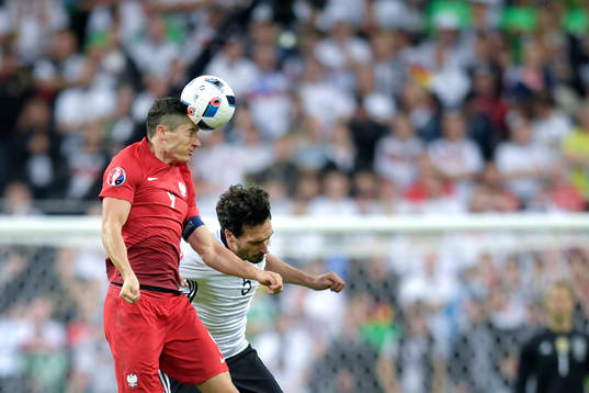 Polens Robert Lewandowski i nickduell med Tysklands Mats Hummels i fotbollsmatchen mellan Tyskland och Polen