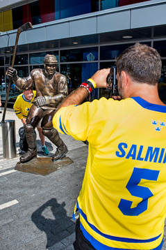 En svensk supporter bli fotograferad vid en staty av Mats