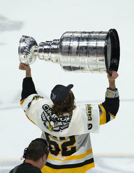 Carl Hagelin of the Pittsburgh Penguins hoists the Stanley