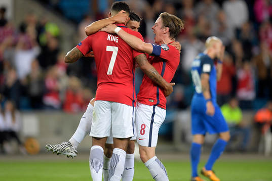 Joshua King of Norway celebrates with Mohamed Elyounoussi and Stefan Johansen after scoring 1-0 by a penalty shot
