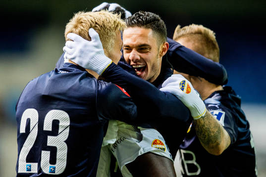 Tokmac Nguen of Strømsgodset (partly hidden) celebrates with teammates Eirik Ulland Andersen and Bassel Jradi after scoring 2-2