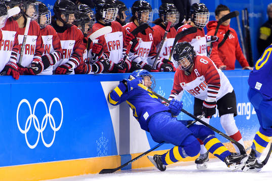 A Swedish player is run over by Akane Hosoyamada of Japan