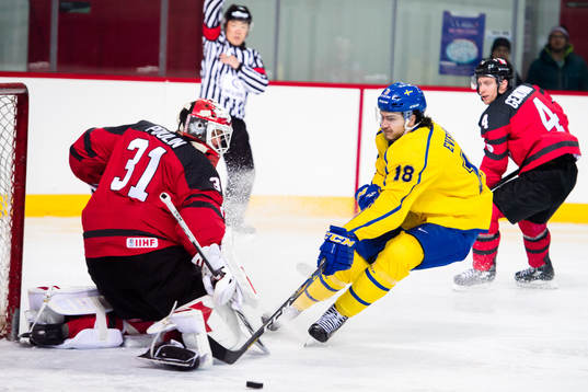 Goaltender Kevin Poulin of Canada and Dennis Everberg of