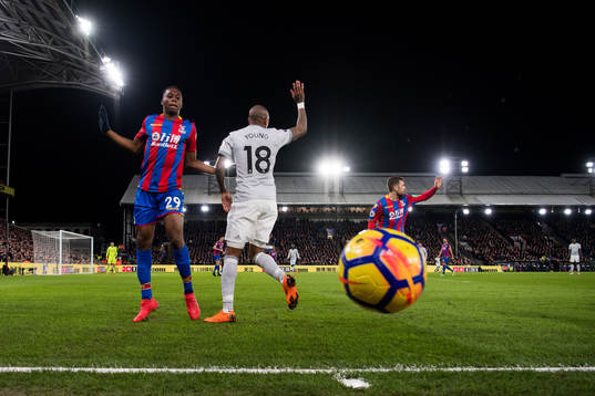 Aaron Wan-Bissaka of Crystal Palace and Ashley Young of
