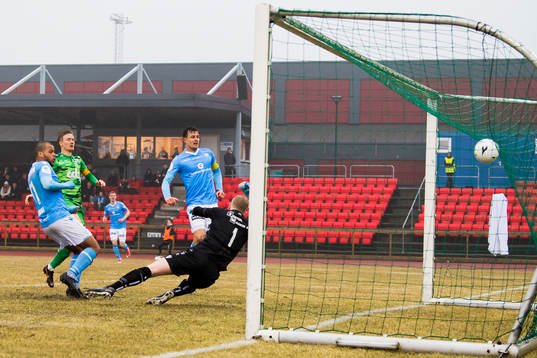 Erixon Danso of Sandnes Ulf scores 1-2 behind goalkeeper Egil Selvik of Nest-Sotra