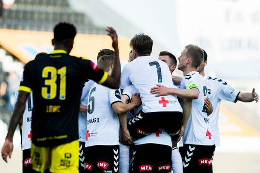 Fredrik Nordkvelle of Odd celebrates with his teammates after scoring 1-0