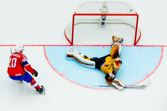 Anders Bastiansen of Norway scores 2-3 behind goaltender