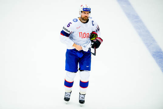 Jonas Holøs of Norway goes off the ice with an injury