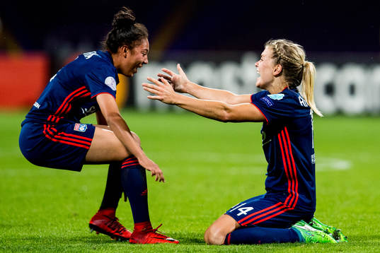 Ada Hegerberg of Lyon celebrates at the final whistle with teammate Selma Bacha