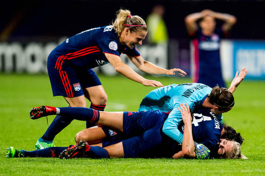 Ada Hegerberg of Lyon celebrates at the final whistle with teammates Eugénie Le Sommer, Pauline Peyraud-Magnin and Selma Bacha