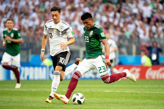 Mesut Özil of Germany and Jesus Gallardo of Mexico