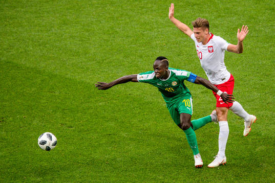 Sadio Mane of Senegal and Lukasz Piszczek of Poland