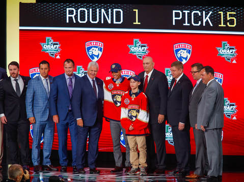 Grigori Denisenko of Russia poses with team representatives
