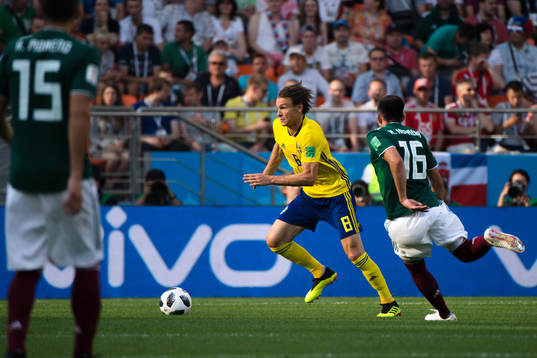 Albin Ekdal of Sweden and Hector Herrera  of Mexico