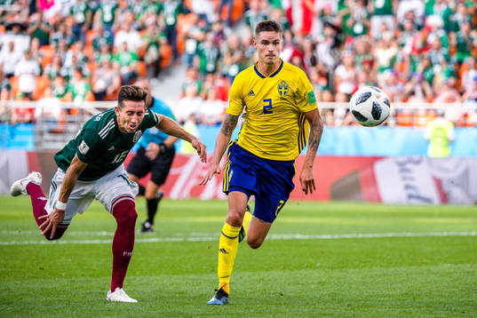 Hector Herrera of Mexico and Mikael Lustig of Sweden