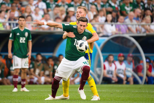Hector Herrera of Mexico and Sebastian Larsson of Sweden