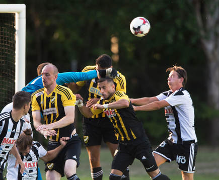 IFK Hässleholms målvakt Adam Larsson boxar bort framför Simon Henningsson, Tommy Filipovic och Mohamed Hamdan i matchen i division 2 mellan Bromölla och IFK Hässleholm i Bromölla 28 juni 2018.  