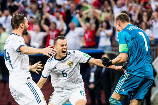Vladimir Granat, Denis Cheryshev and goalkeeper Igor Akinfeev of Russia celebrates after the penalty shoot-out