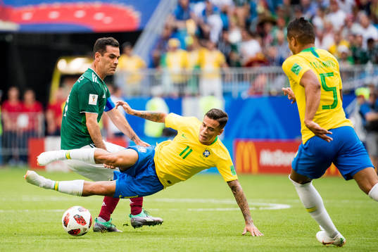Rafael Marquez of Mexico and Philippe Coutinho of Brazil