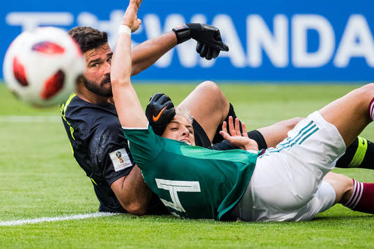 Javier Hernandez of Mexico and goalkeeper Alisson of Brazil