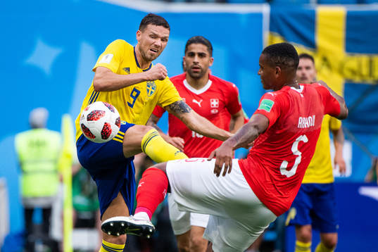 Marcus Berg of Sweden competes for the ball with Manuel