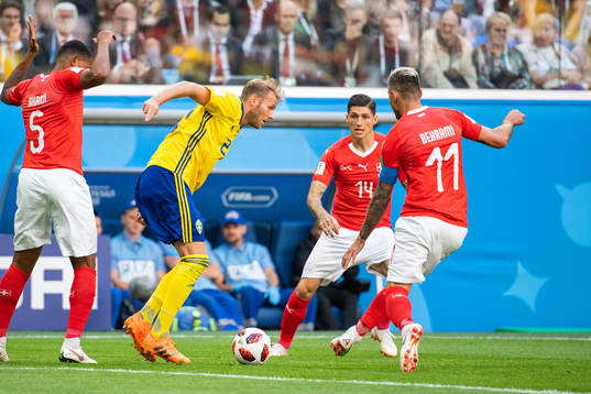 Ola Toivonen of Sweden competes for the ball with Valon