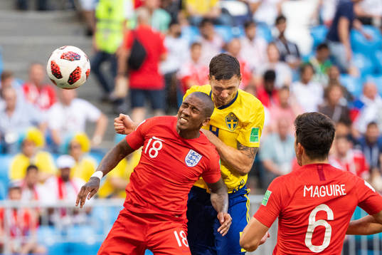 Ashley Young of England and Marcus Berg of Sweden competes