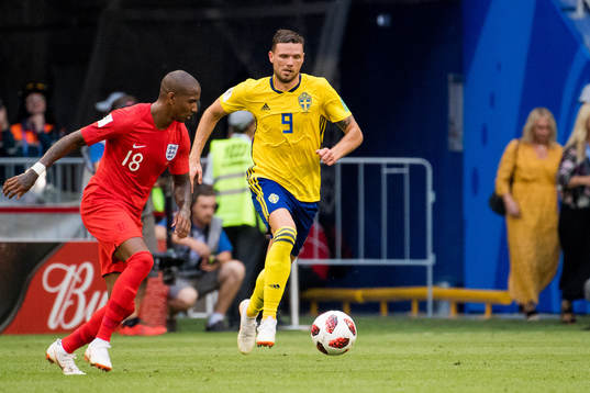 Ashley Young of England and Marcus Berg of Sweden