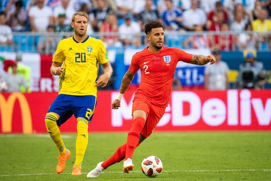 Kyle Walker of England competes for the ball with Ola