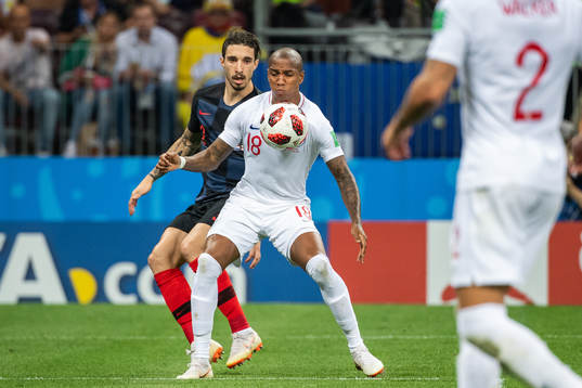 Ashley Young of England competes for the ball with Sime
