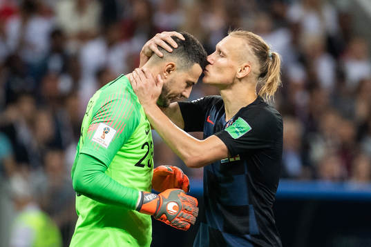 Domagoj Vida kisses goalkeeper Danijel Subasic of Croatia
