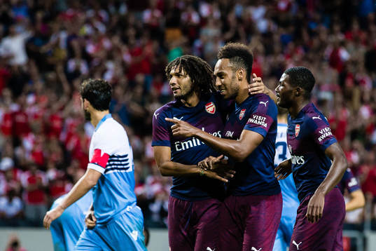 Pierre-Emerick Aubameyang of Arsenal celebrates with teammates Mohamed Elneny and Ainsley Maitland-Niles after 2-0