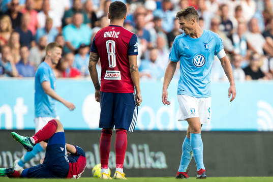 Markus Rosenberg of Malmö FF reacts against Boban Nikolov of Vidi