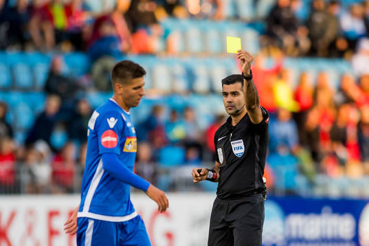 Emil Palsson of Sandefjord is shown a yellow card by rRohit Saggi, referee,