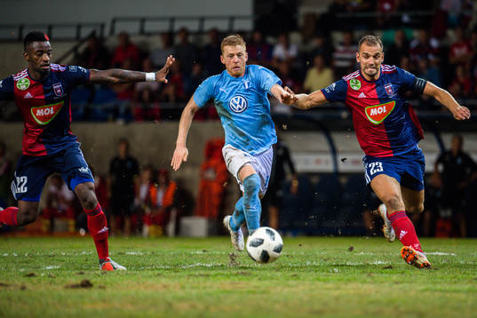 Anders Christiansen of Malmö FF against Stopira and Roland Juhasz of Vidi