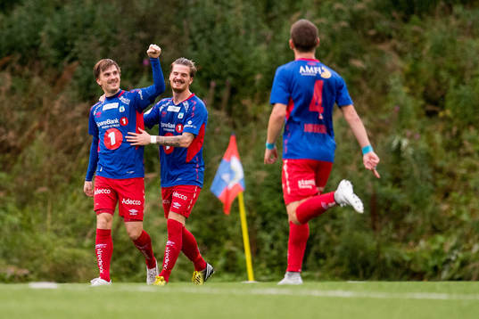 Vegard Lysvoll of Tromsdalen celebrates the 2-0 goal with his teammates