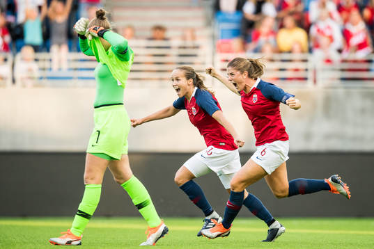 Maren Mjelde and Guro Reiten of Norway celebrate at the final whistle while goalkeeper Sari van Veenendaal of Netherlands looks dejected during the FIFA Women's World Cup Qualifier match between Norway and Netherlands on September 4, 2018 in Oslo.
