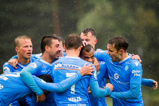Erixon Danso of Sandnes Ulf celebrates with his teammates after scoring 1-3