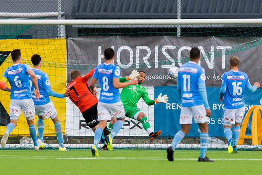 Tomas Kristoffersen of Åsane and goalkeeper Nicklas Frenderup of Sandnes Ulf