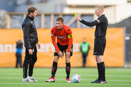 Jonas Hestetun of Åsane is shown a yellow card by referee Eivind Bodding