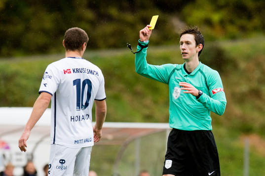 Tommy Høiland of Viking is shown a yellow card by Sivert Øksnes Amland, referee,