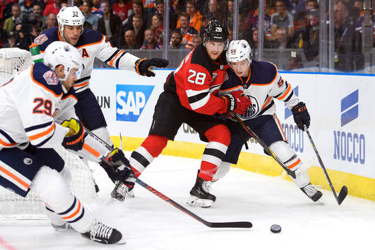 Damon Severson of the New Jersey Devils and Kailer Yamamoto